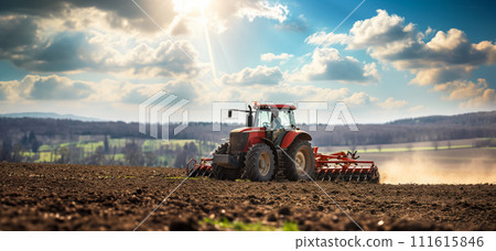 A tractor works in the field and plows the land, preparing the field for sowing, the concept - Earth Hour and caring for the future harvest, seasonal work on the farm 111615846