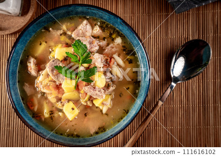 Pea soup with pieces of white sausage, potatoes and small dumplings. Pea soup with pieces of white sausage, potatoes and small dumplings. 111616102
