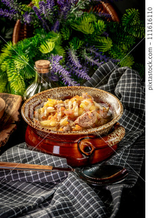 Pea soup with pieces of white sausage, potatoes and small dumplings. Pea soup with pieces of white sausage, potatoes and small dumplings. 111616110
