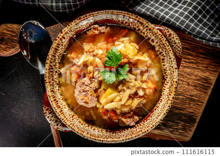 Pea soup with pieces of white sausage, potatoes and small dumplings. Pea soup with pieces of white sausage, potatoes and small dumplings. 111616115