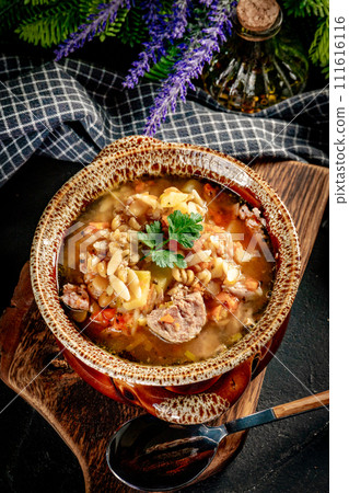 Pea soup with pieces of white sausage, potatoes and small dumplings. Pea soup with pieces of white sausage, potatoes and small dumplings. 111616116