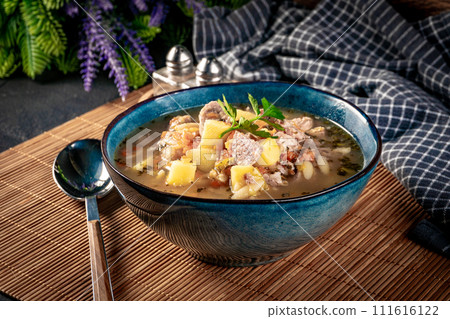 Pea soup with pieces of white sausage, potatoes and small dumplings. Pea soup with pieces of white sausage, potatoes and small dumplings. 111616122