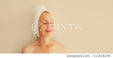 Natural beauty portrait of happy woman enjoying drying wet hair with bath towel after shower Natural beauty portrait of happy woman enjoying drying wet hair with bath towel after shower 111616236