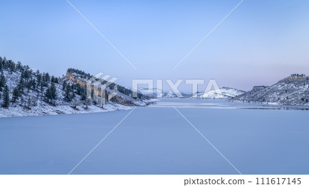 winter dusk over partially frozen Horsetooth Reservoir at foothills of northern Colorado 111617145