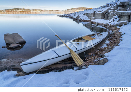 decked expedtion canoe on a shore of Carter Lake in northern Colorado in winter scenery decked expedtion canoe on a shore of Carter Lake in northern Colorado in winter scenery 111617152