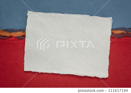 small sheet of blank white Khadi rag paper from India against abstract landscape with a pen 111617194