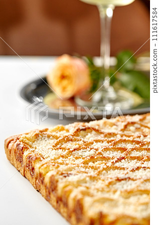Lattice cheese galette with parmesan crumbs served in romantic setting Lattice cheese galette with parmesan crumbs served in romantic setting 111617584