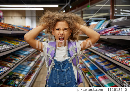 Stressed girl child feeling crazy during shopping at stationery shop 111618340