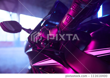 Motor biker driving sport motorcycle in neon light 111618400