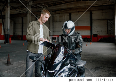 Motorcyclist passing driving exam at private school to get license Motorcyclist passing driving exam at private school to get license 111618443