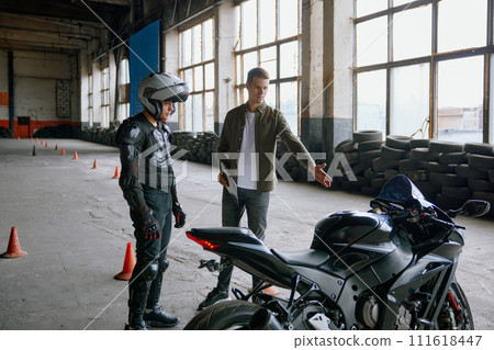 First driving lesson at motorcycle school in indoor motordrome 111618447