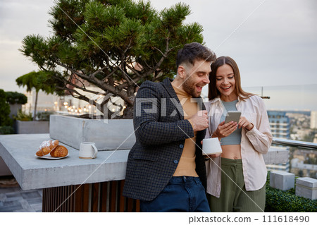 Business colleagues chitchatting during coffee break at office roof Business colleagues chitchatting during coffee break at office roof 111618490