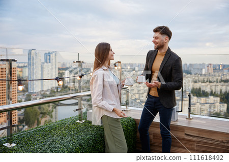 Business colleagues chitchatting during coffee break at office roof terrace 111618492