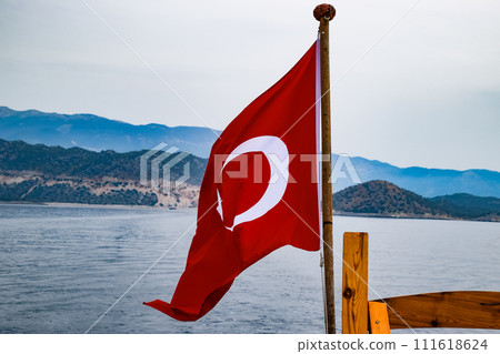 The flag of Turkey flutters in the wind on the deck of pleasure yacht. 111618624