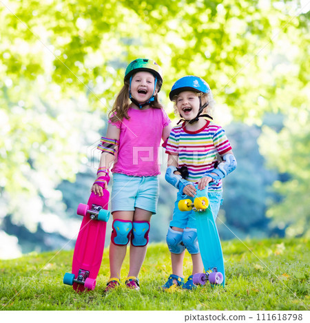 Children riding skateboard in summer park 111618798