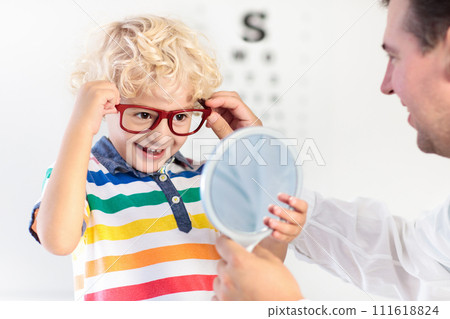 Child at eye sight test. Kid at optitian. Eyewear for kids. Child at eye sight test. Kid at optitian. Eyewear for kids. 111618824