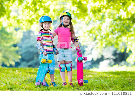 Children riding skateboard in summer park 111618831