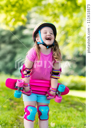 Child riding skateboard in summer park 111618873