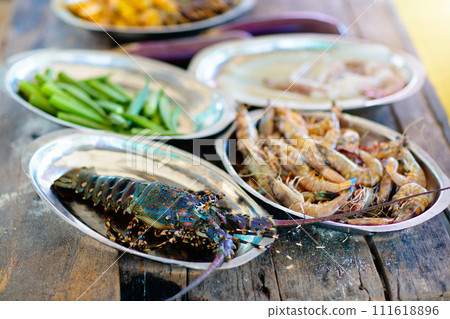 Seafood grill on the beach. Lobster and fish BBQ 111618896