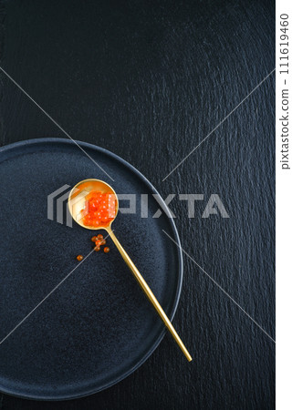 Red caviar in the golden spoon 111619460