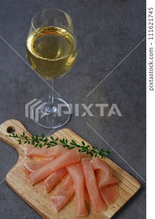 Enjoy salty and delicious raw ham as a snack and drink dry white wine. Enjoy salty and delicious raw ham as a snack and drink dry white wine. 111621745