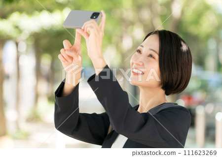 Business woman taking a photo with a smartphone 111623269