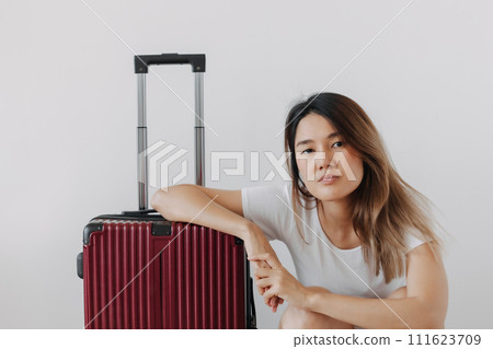 Bored and tired face woman in her private loungewear and baggage isolated on white. 111623709