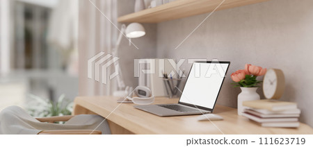 Side view of a laptop mockup and accessories on a table in a beautiful Scandinavian home office. 111623719