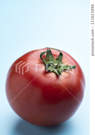 Bright red ripe tomatoes on a light blue background 111623898