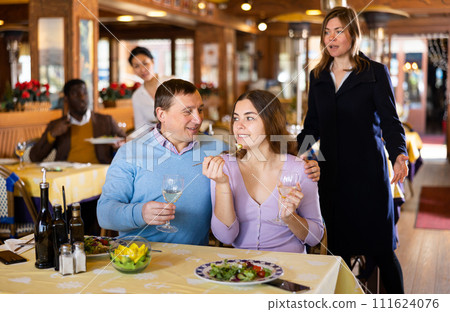 Woman catching husband with young mistress in restaurant Woman catching husband with young mistress in restaurant 111624076