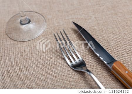 Fork and knife - cutlery on banquet table closeup Fork and knife - cutlery on banquet table closeup 111624132