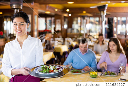 Portrait of positive waitress in restaurant 111624227