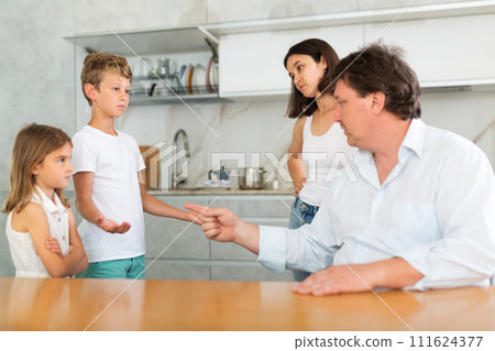 Parents scold their children in kitchen at home 111624377