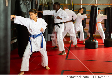 Latino woman is practicing different kicks at gym 111624486