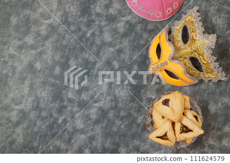 Jewish Purim holiday symbol with hamantaschen hamans ears cookies, carnival mask, noisemaker 111624579