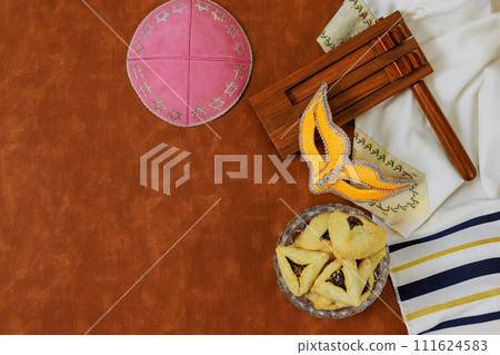 A key symbol Jewish festival of Purim is rattle, carnival mask, hamantaschen cookies. 111624583