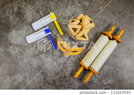 Symbol celebration Jewish Purim holiday with hamantaschen hamans ears cookies, carnival mask, noisemaker 111624593