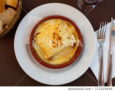 Traditional Italian dish is lasagna baked in oven under cheese crust. 111624649