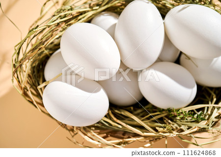 Wicker basket with farm natural white eggs. Wicker basket with farm natural white eggs. 111624868