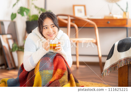 College woman drinking tea in her room College woman drinking tea in her room 111625221
