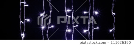 Christmas and New Year Decoration Lights, Garland with Small  Led Lamps Shining on Black Background. Christmas and New Year Decoration Lights, Garland with Small  Led Lamps Shining on Black Background. 111626390