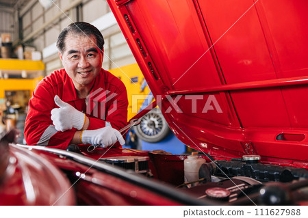 Happy senior professional Asian male mechanic garage worker happy working replace maintenance car service in auto workshop Happy senior professional Asian male mechanic garage worker happy working replace maintenance car service in auto workshop 111627988