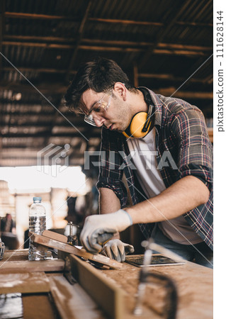 professional carpenter man hand working make wooden handcraft furniture master workpiece fine detail artisan with wood workshop. 111628144