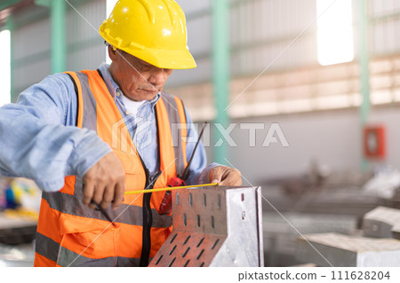 Construction engineer builder install perforated tray metal wireway cable duct rail in large industry building. 111628204