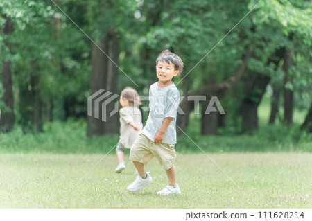 Active children chasing each other in the park, siblings, running, sprinting 111628214
