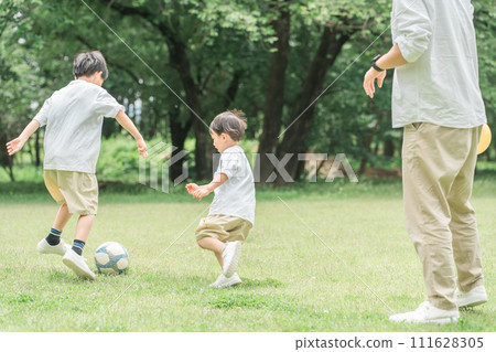 兄弟，朋友，男孩，父母和孩子，父親在公園的草地上踢足球（足球，運球） 111628305