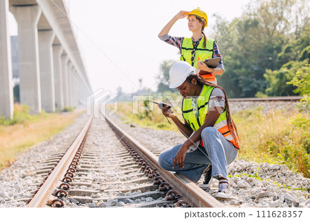 Engineer female railway tracks service team working on site survey check maintenance inspection train track for new construction and safety check Engineer female railway tracks service team working on site survey check maintenance inspection train track for new construction and safety check 111628357