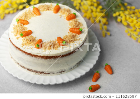 Homemade carrot cake made with walnuts, iced with cream cheese. Sweet dessert. Homemade carrot cake made with walnuts, iced with cream cheese. Sweet dessert. 111628597