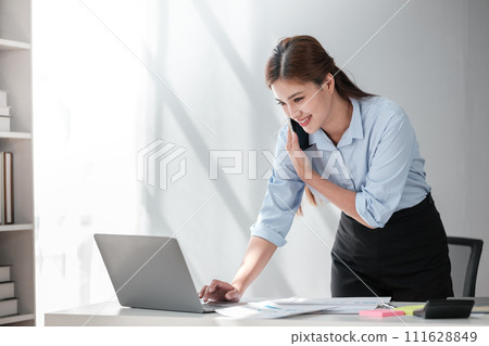 Asian Business woman using calculator and laptop for doing math finance on an office desk, tax, report, accounting, statistics, and analytical research concept Asian Business woman using calculator and laptop for doing math finance on an office desk, tax, report, accounting, statistics, and analytical research concept 111628849