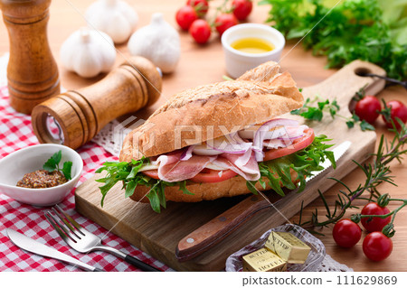 Baguette sandwich with plenty of toppings Baguette sandwich with plenty of toppings 111629869